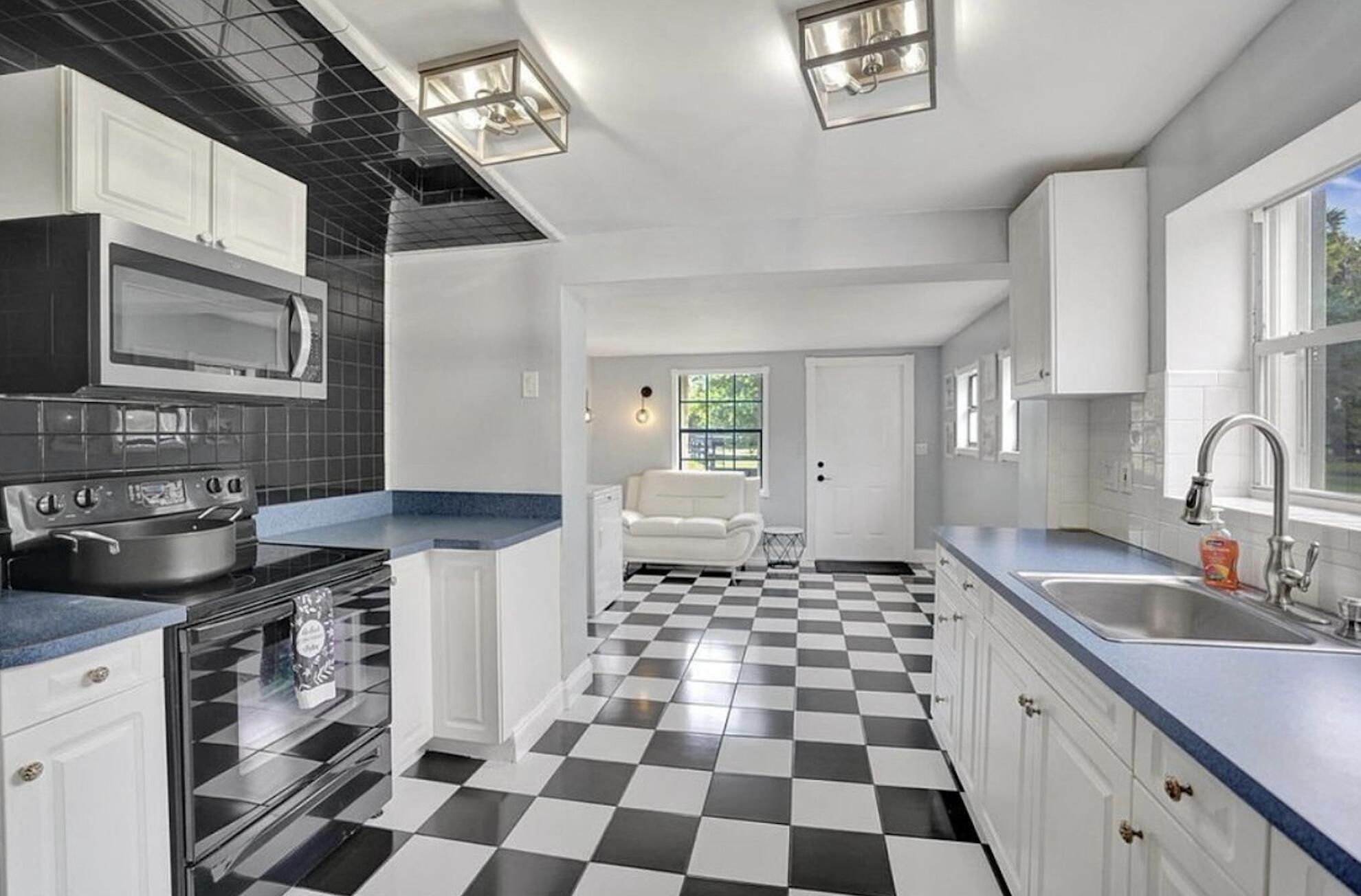 502 Rambling Dr Circle, Unit #2 Wellington, FL 33414 - Photo 15 of 18 a kitchen with a sink a stove and cabinets