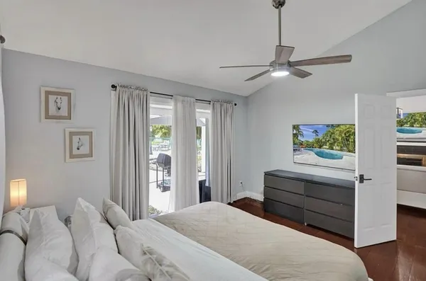 a bedroom with a bed and a chandelier