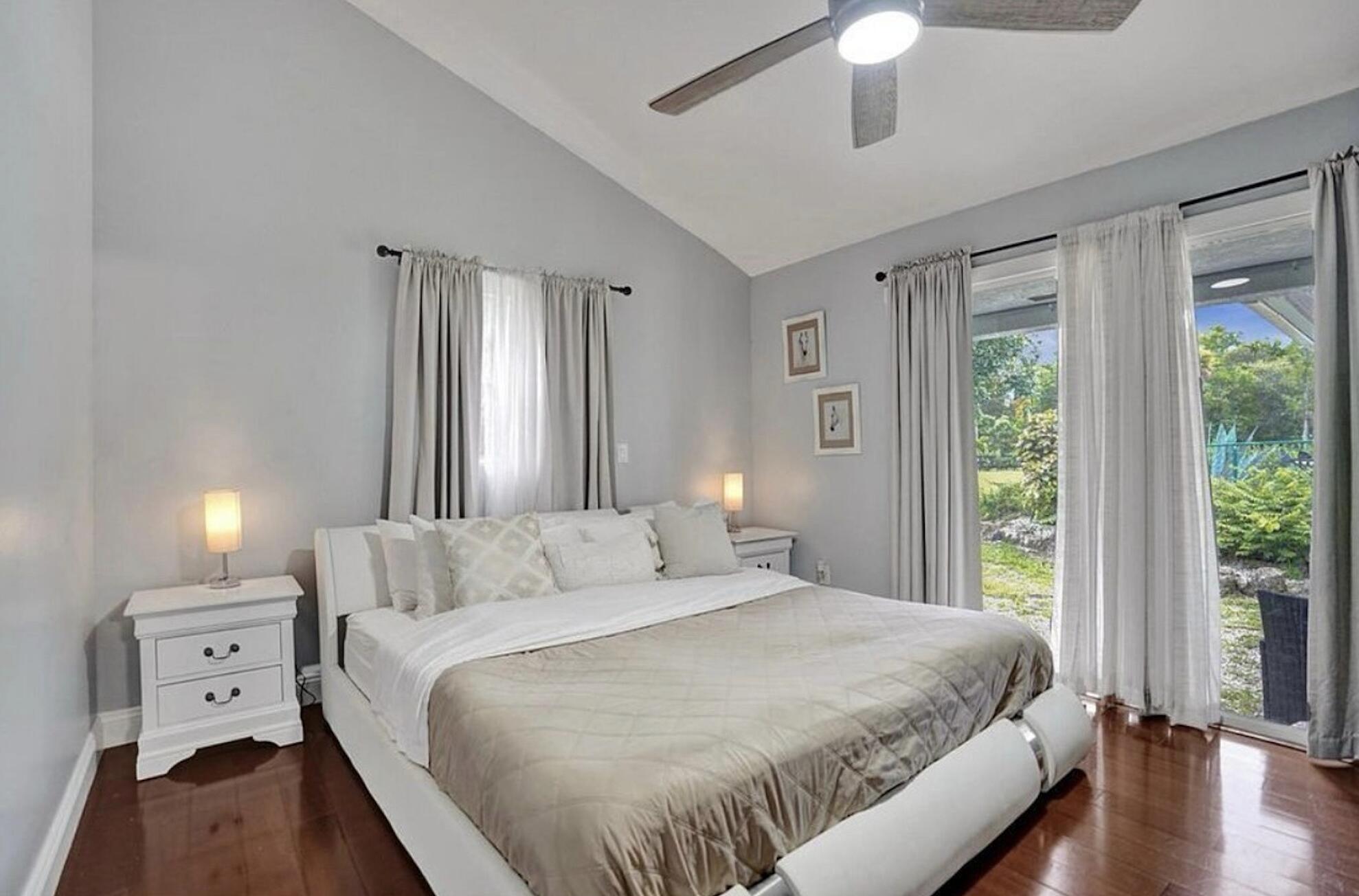 502 Rambling Dr Circle, Unit #2 Wellington, FL 33414 - Photo 9 of 18 a bedroom with a large bed and a window