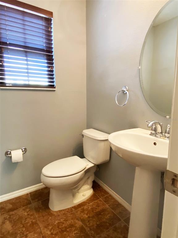8946 White Sage Loop Lakewood Ranch, FL 34202 - Photo 13 of 36 a bathroom with a sink toilet and a mirror