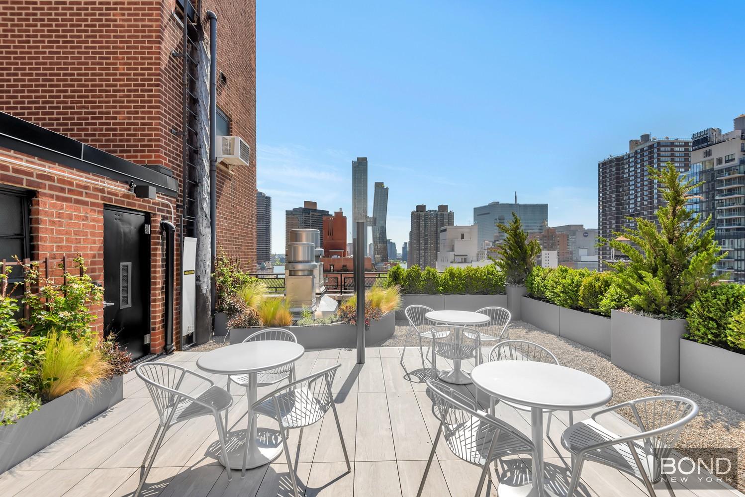 210 East 36th Street, Unit 5E Manhattan, NY 10016 - Photo 12 of 12 a view of a patio with a table and chairs and potted plants