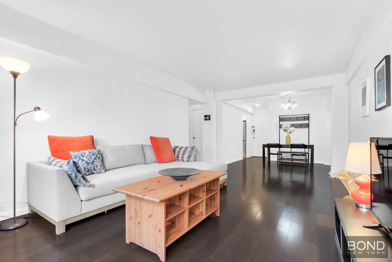 210 East 36th Street, Unit 5E Manhattan, NY 10016 - Photo 2 of 12 a living room with furniture and a dining table with wooden floor