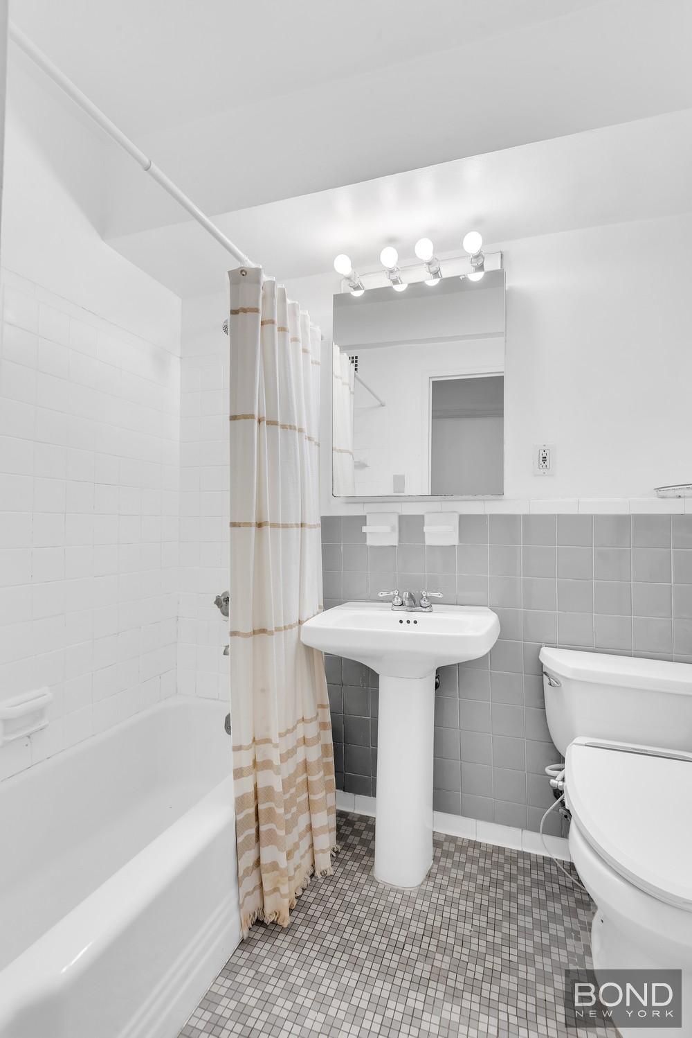 210 East 36th Street, Unit 5E Manhattan, NY 10016 - Photo 6 of 12 a bathroom with a sink a toilet and shower
