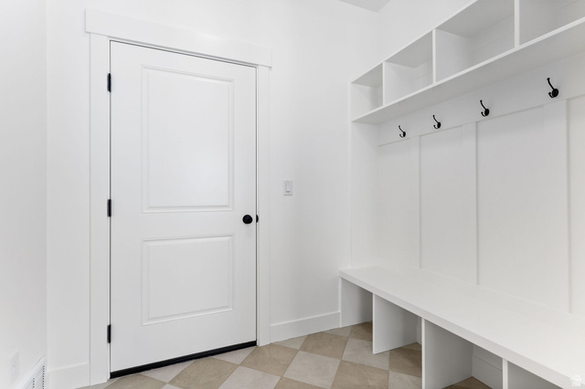1144 South 4475 West West Point, UT 84015 - Photo 12 of 30 Entryway featuring built-in white storage cubbies, a bench, and a coat rack with black hooks