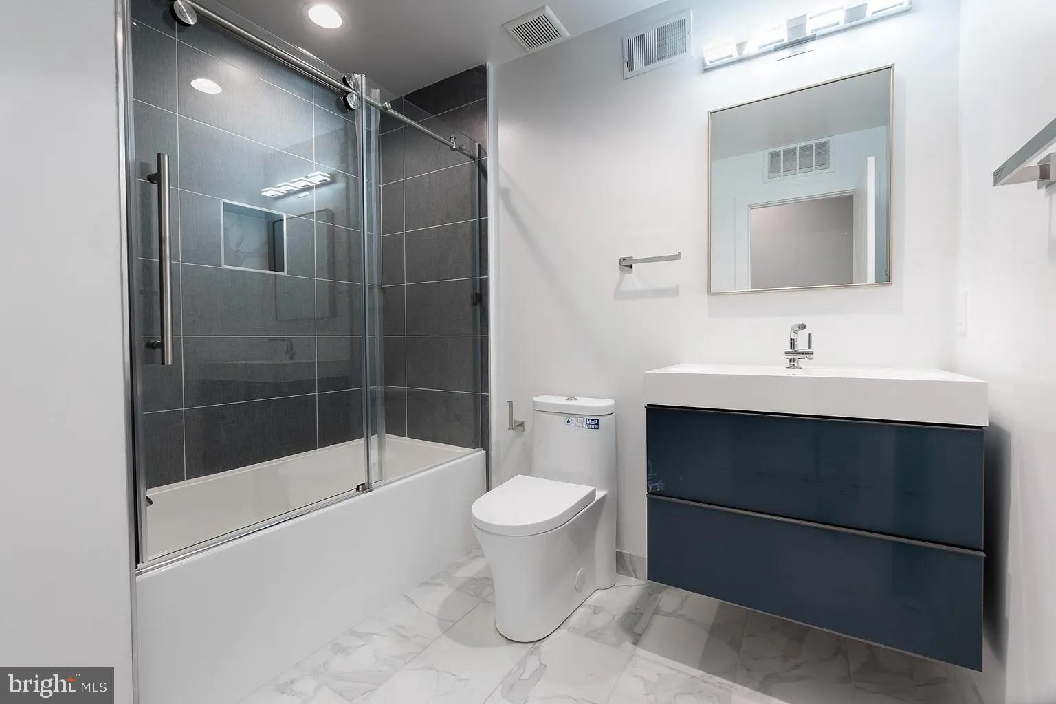 2055 Tasker Street Philadelphia, PA 19145 - Photo 18 of 40 a bathroom with a sink toilet and shower