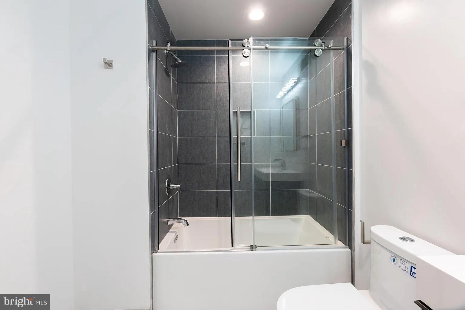 2055 Tasker Street Philadelphia, PA 19145 - Photo 19 of 40 a bathroom with a shower a toilet and a bathtub