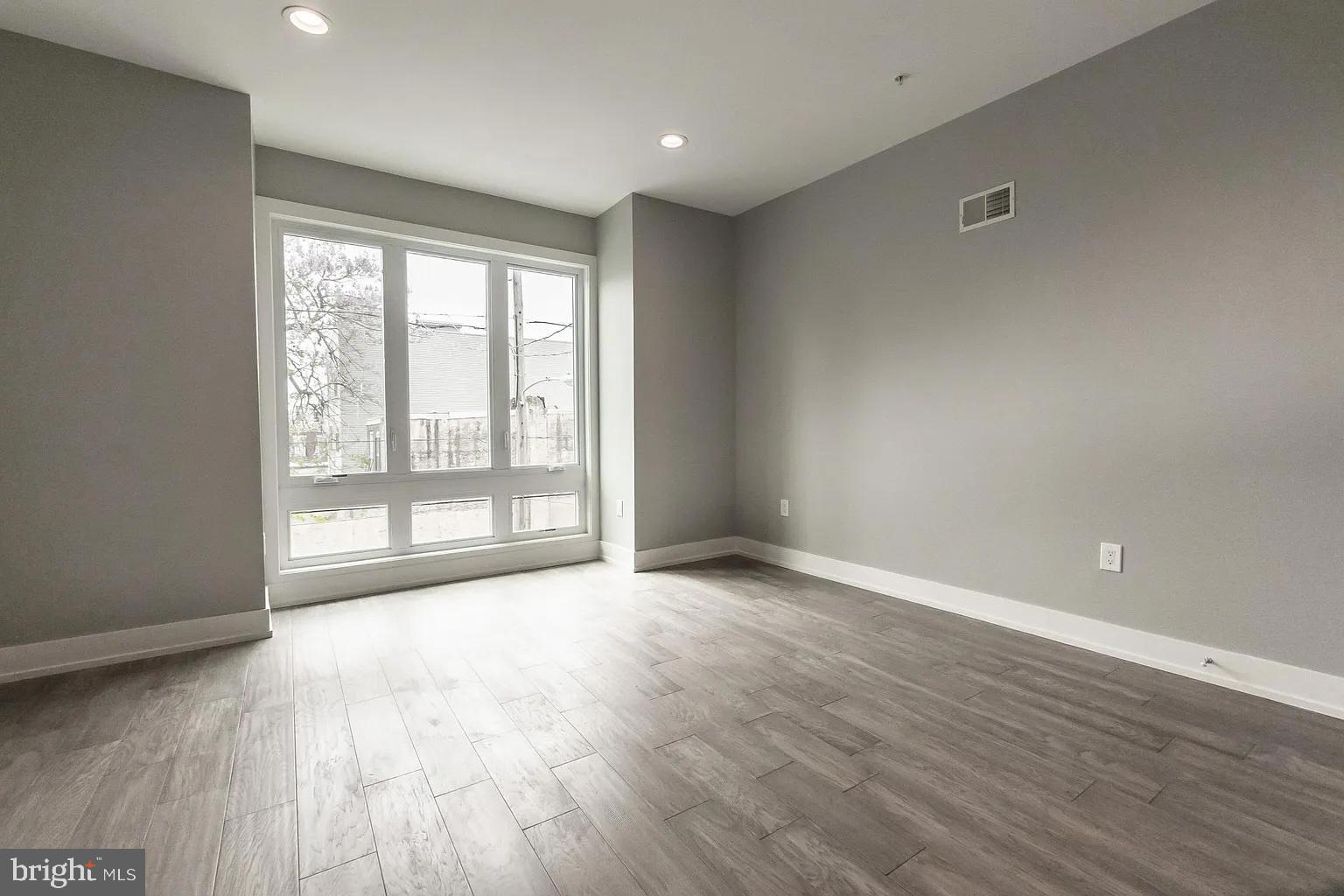 2055 Tasker Street Philadelphia, PA 19145 - Photo 22 of 40 wooden floor in an empty room with a window