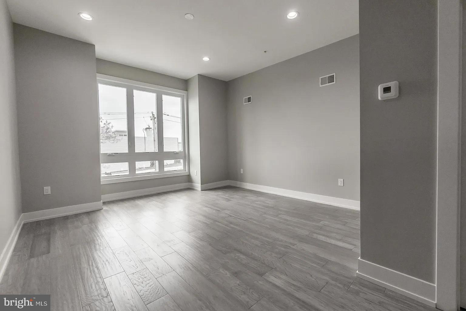2055 Tasker Street Philadelphia, PA 19145 - Photo 31 of 40 wooden floor in an empty room with a window