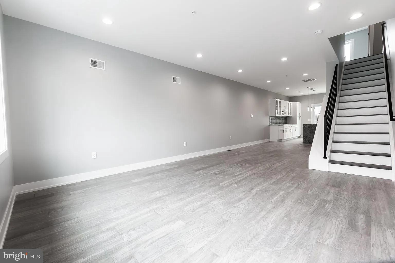 2055 Tasker Street Philadelphia, PA 19145 - Photo 4 of 40 an empty room with wooden floor and entryway