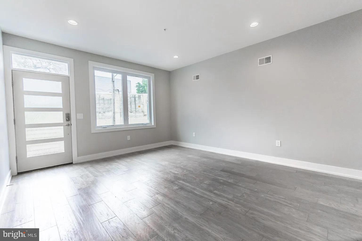 2055 Tasker Street Philadelphia, PA 19145 - Photo 5 of 40 an empty room with wooden floor and windows