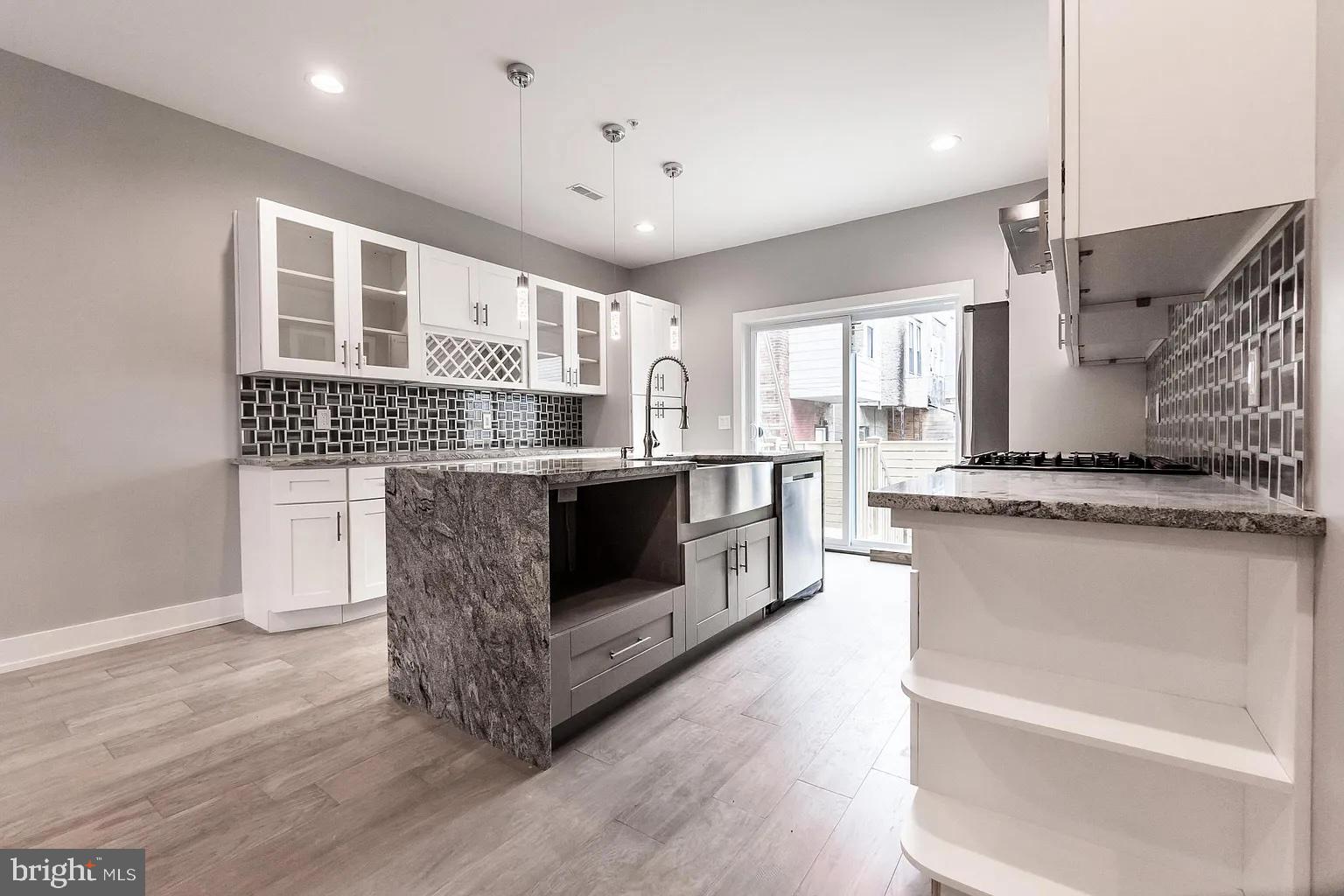 2055 Tasker Street Philadelphia, PA 19145 - Photo 6 of 40 a kitchen with stainless steel appliances granite countertop a stove and a sink