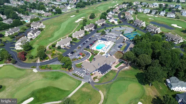 an aerial view of a residential houses with outdoor space and street view