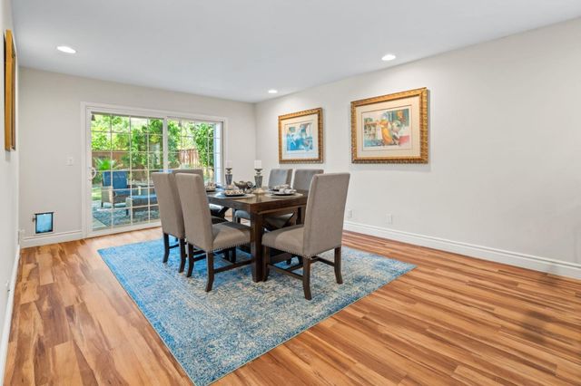 a dining room with furniture and wooden floor