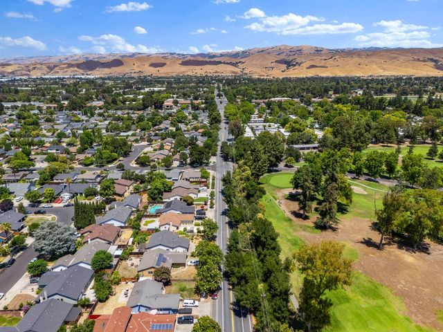 an aerial view of residential houses with outdoor space