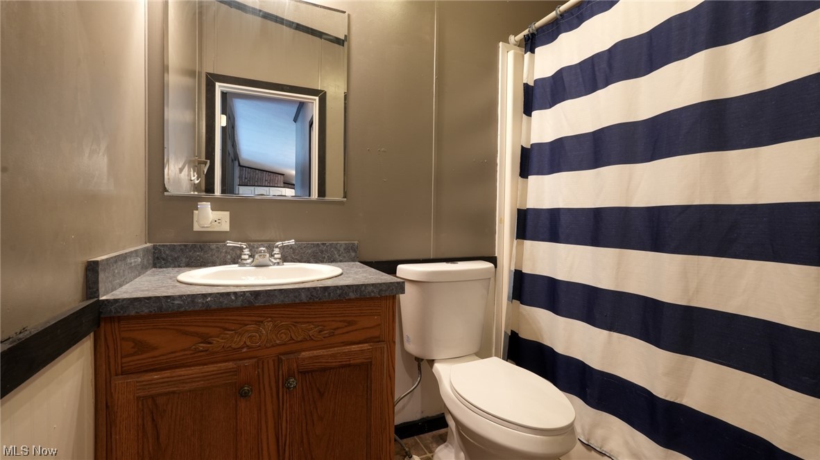 70871 Angus Road Cambridge, OH 43725 - Photo 26 of 29 Bathroom featuring vanity and mirror