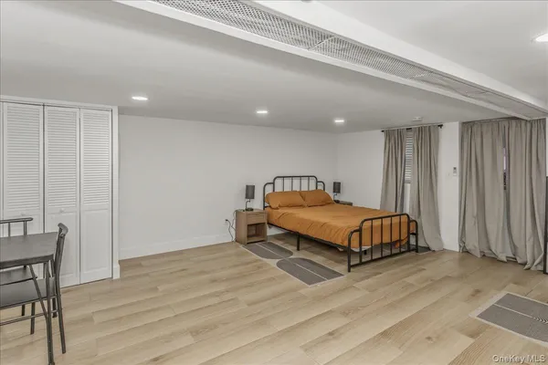 a bedroom with a bed and chair