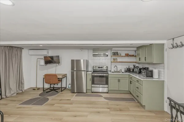 a kitchen with stainless steel appliances a stove a sink and a refrigerator