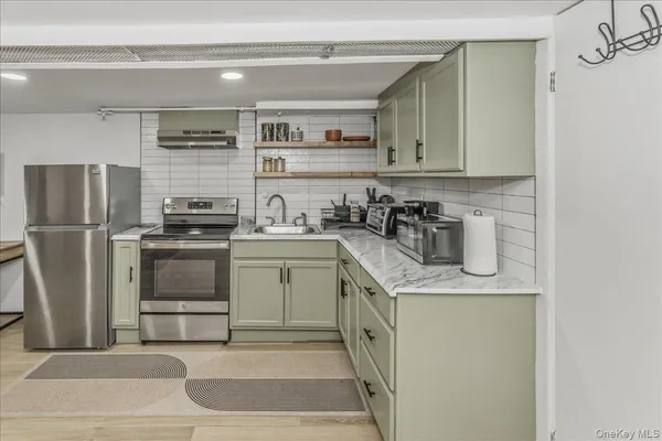 a kitchen with appliances cabinets and a counter top space