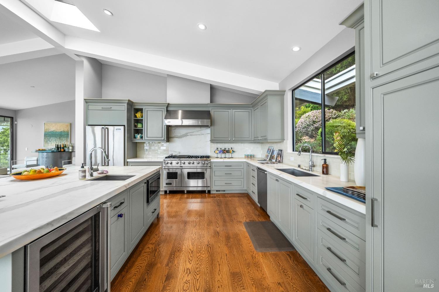 30 Eucalyptus Road Belvedere, CA 94920 - Photo 15 of 46 a large kitchen with stainless steel appliances lots of counter top space a sink a stove and a window