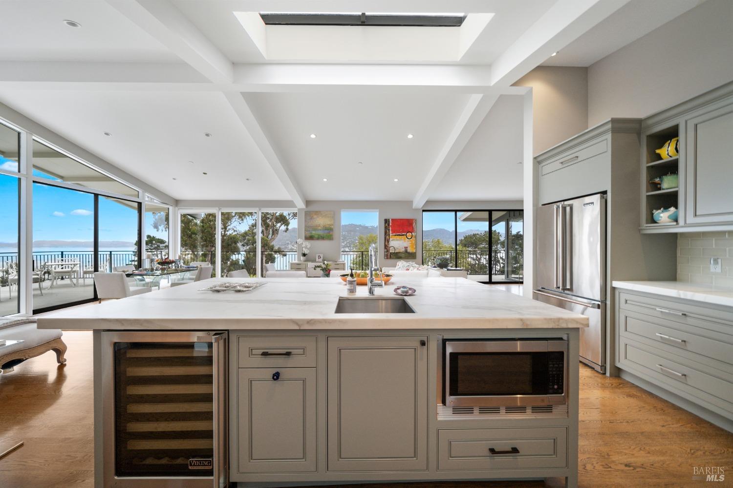 30 Eucalyptus Road Belvedere, CA 94920 - Photo 18 of 46 a kitchen with kitchen island stainless steel appliances a sink and cabinets