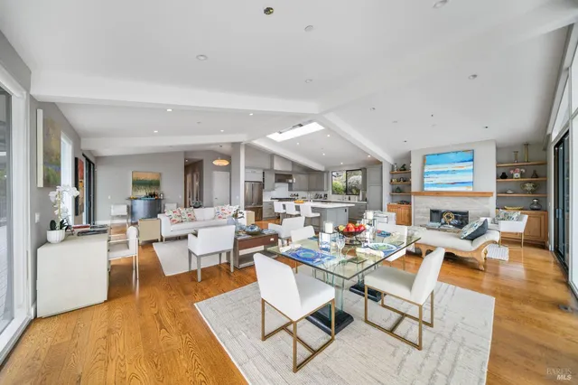 a living room with fireplace furniture and a wooden floor