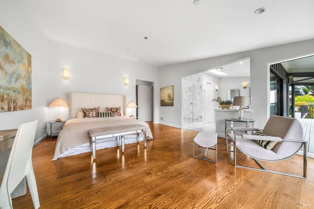 a bedroom with a bed and glass table chair