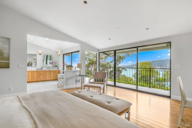 a living room with hardwood floor and a large window