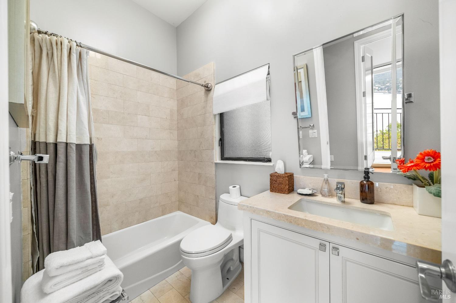 30 Eucalyptus Road Belvedere, CA 94920 - Photo 33 of 46 a bathroom with a sink a toilet a mirror and shower