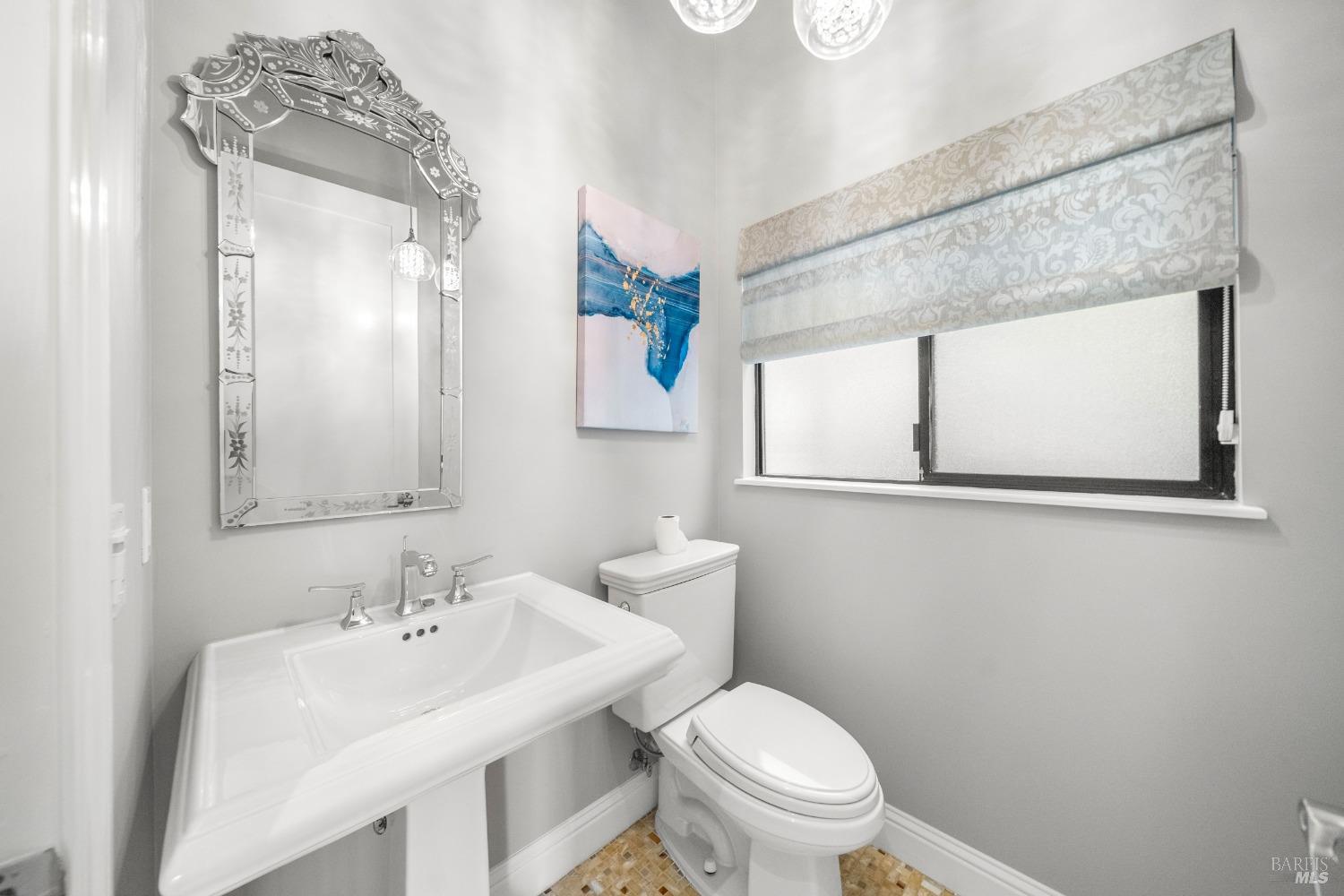 30 Eucalyptus Road Belvedere, CA 94920 - Photo 34 of 46 a bathroom with a toilet a sink and mirror