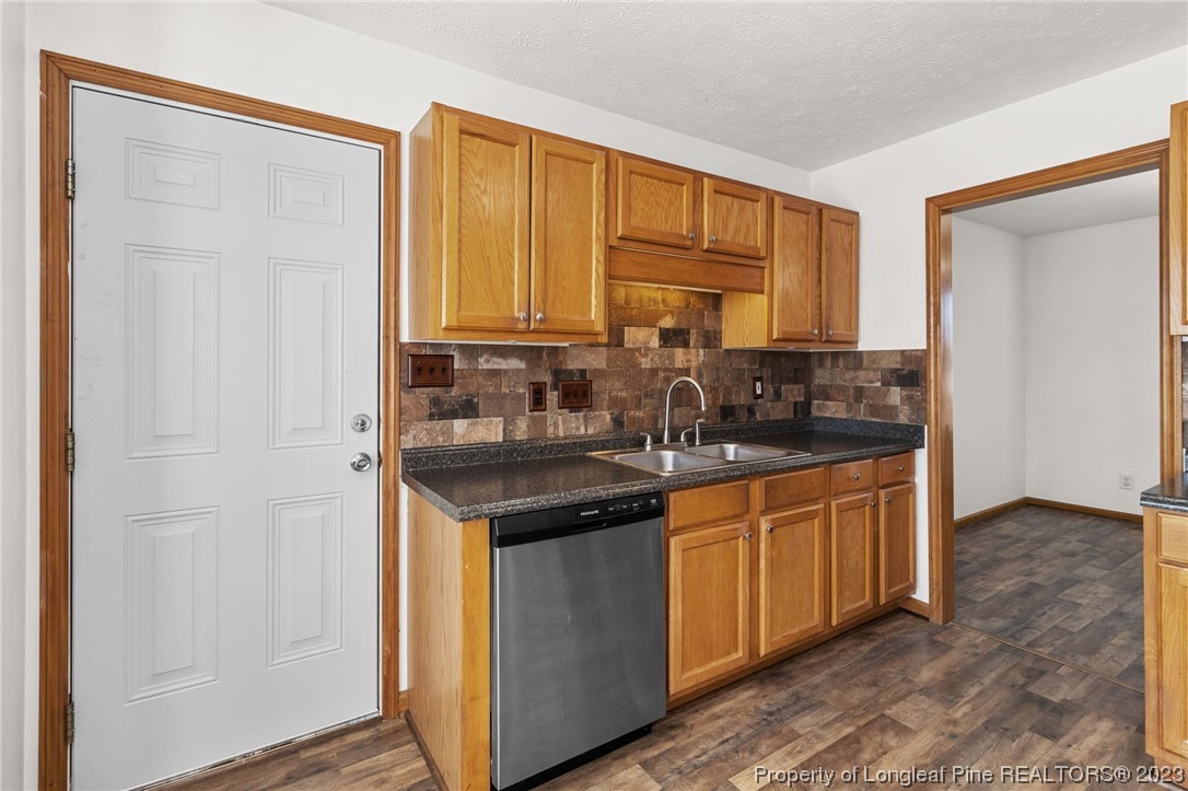 342 Robeson Street Spring Lake, NC 28390 - Photo 15 of 42 a kitchen with stainless steel appliances granite countertop a sink and a refrigerator