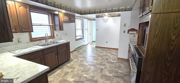 a kitchen with granite countertop a refrigerator and a sink