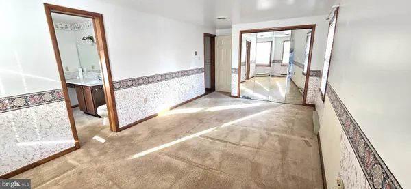 a view of bathroom with a toilet sink and mirror