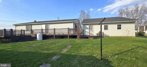 a view of a house with backyard and porch