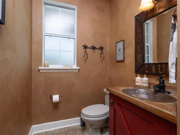 a bathroom with a sink a toilet and mirror