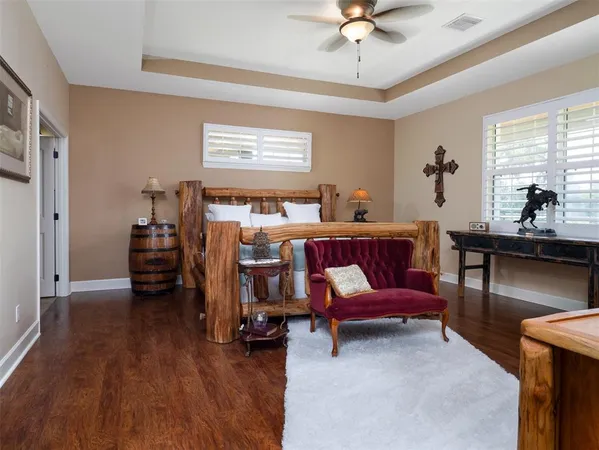 a bedroom with a bed and a chandelier