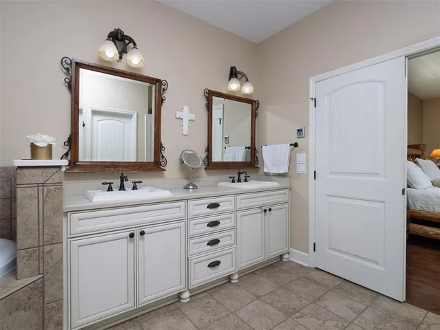 a bathroom with a granite countertop sink vanity and mirror