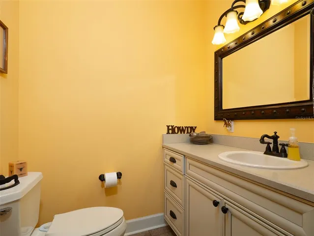 a bathroom with a sink a toilet and mirror