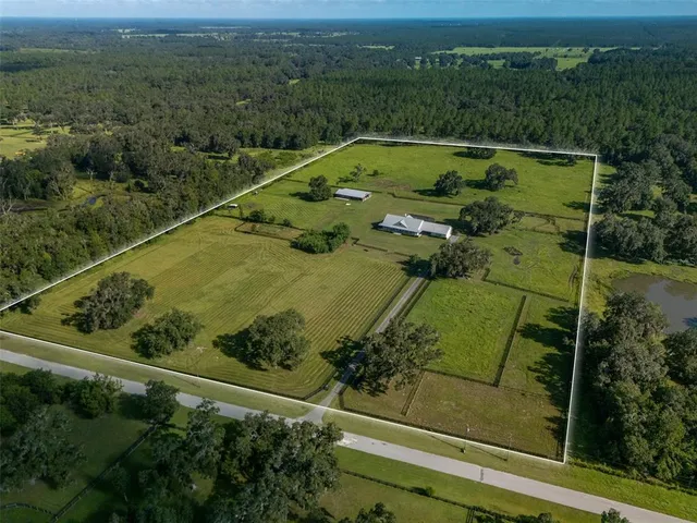 an aerial view of a residential houses with outdoor space
