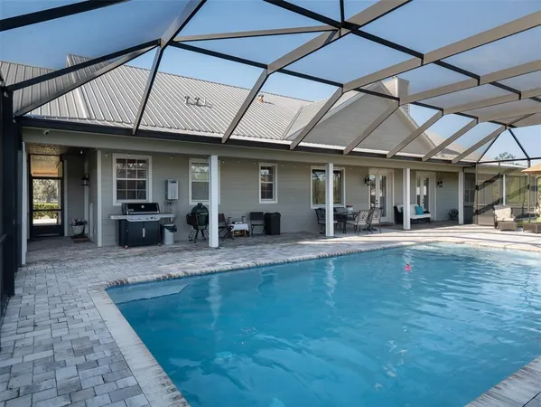 an aerial view of a house with big yard