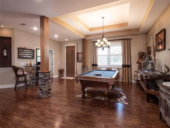 a room with lots of chairs and wooden floor