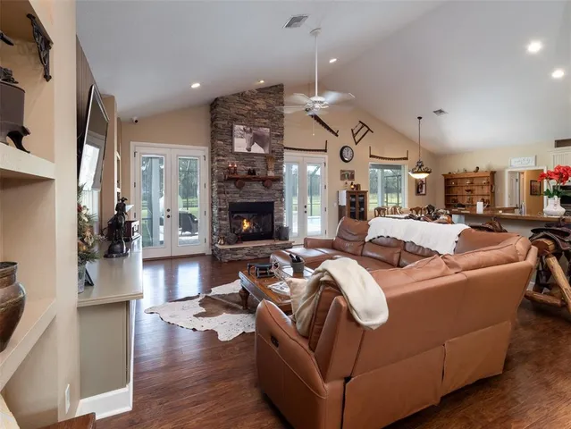 a living room with furniture fireplace and wooden floor