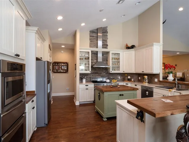 a kitchen with cabinets and wooden floor