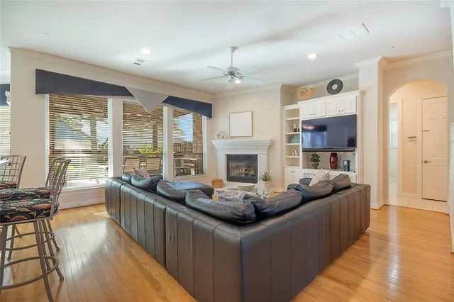 a living room with fireplace furniture and a wooden floor