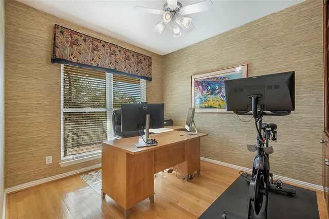 a view of a workspace with furniture and a window