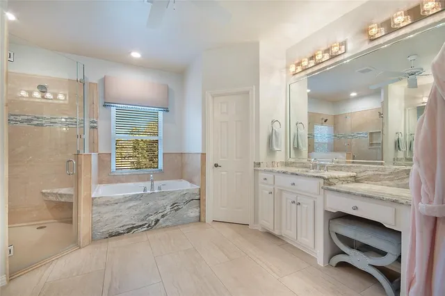 a bathroom with a granite countertop sink a mirror and a shower
