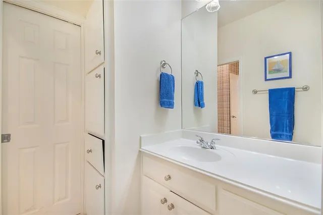 a bathroom with a double vanity sink a tub and a mirror