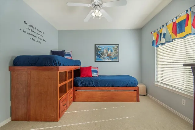 a bedroom with a bed and painting on the wall