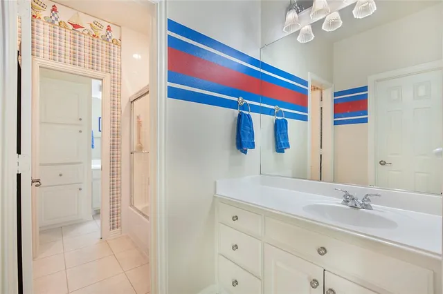 a bathroom with a sink a vanity and a mirror