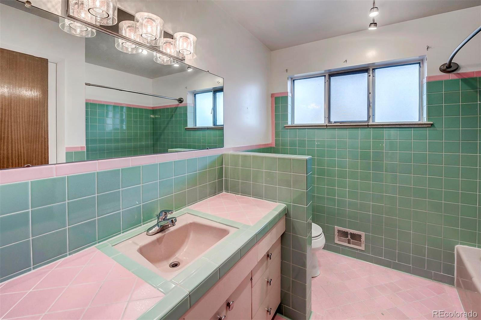 3880 Allison Street Wheat Ridge, CO 80033 - Photo 12 of 18 a bathroom with a sink mirror and shower