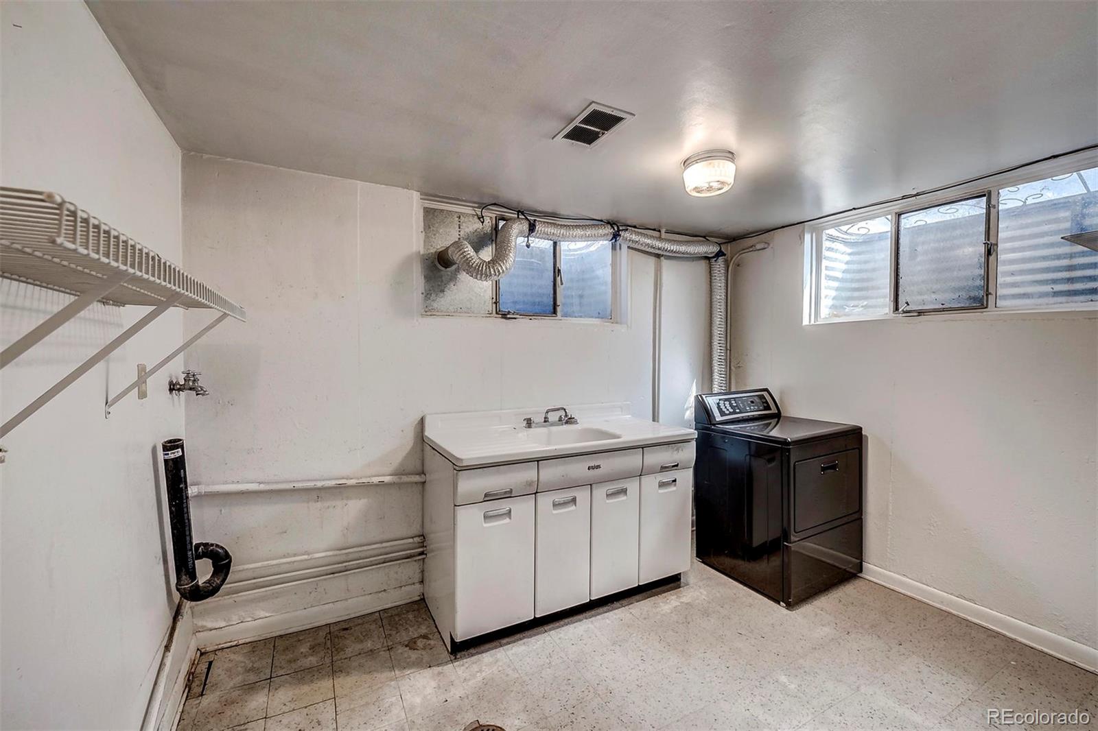 3880 Allison Street Wheat Ridge, CO 80033 - Photo 15 of 18 a kitchen with a stove and a refrigerator